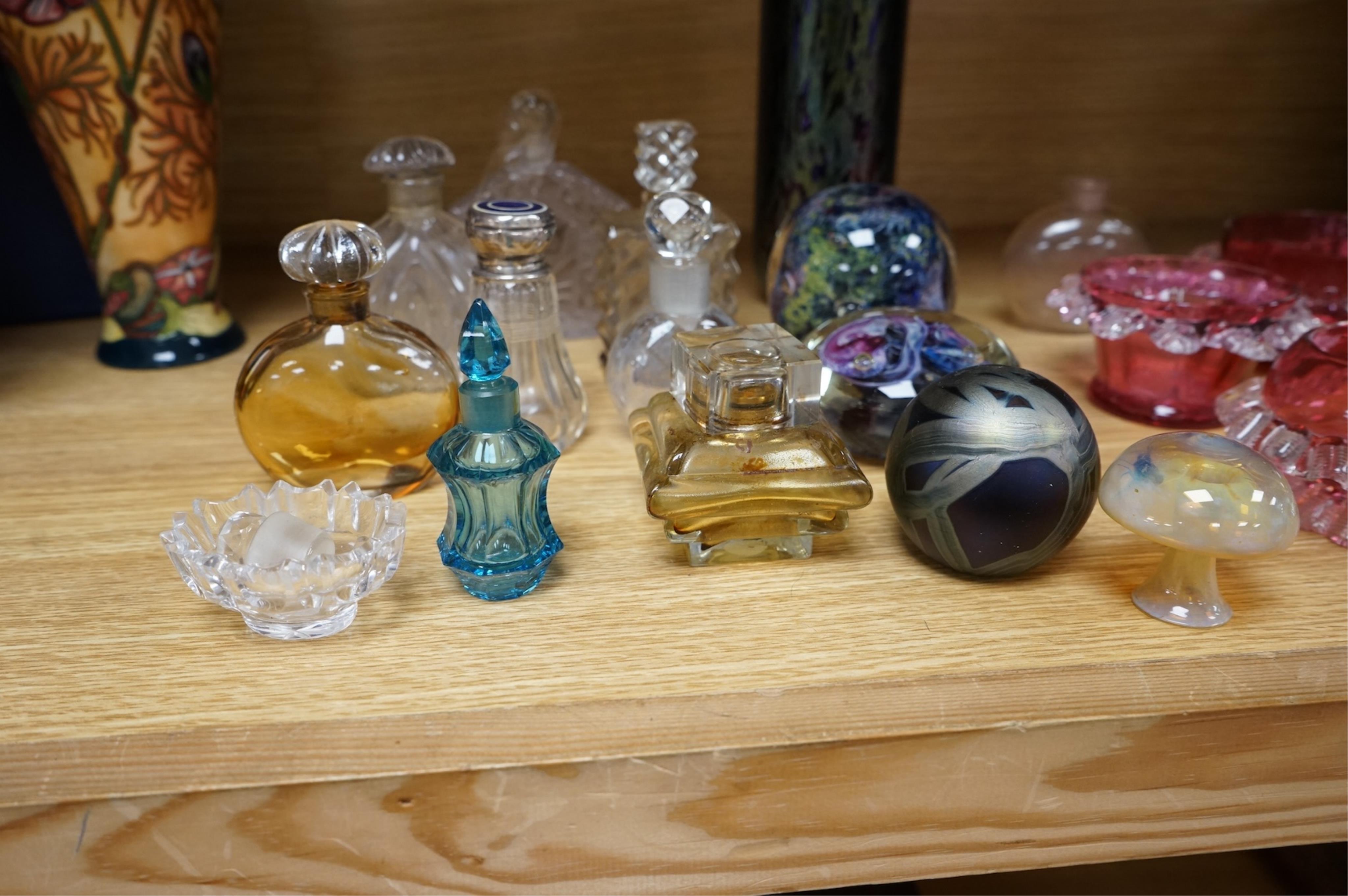 A collection of scent bottles, cranberry glass salts, three glass paperweights and a vase. tallest 18cm high